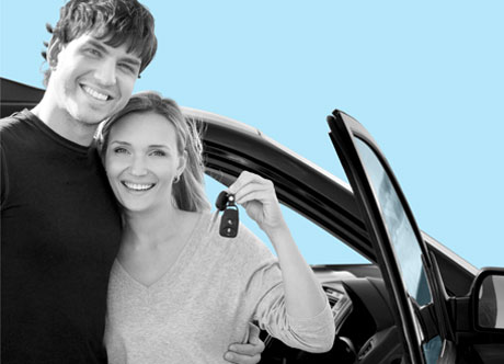 Happy couple holding car keys